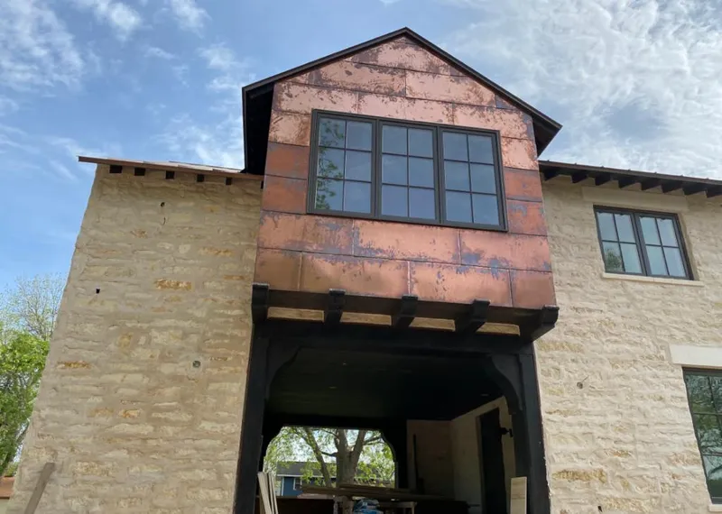 Copper metal panel facade on a stone building for Roof Repair in Conshohocken